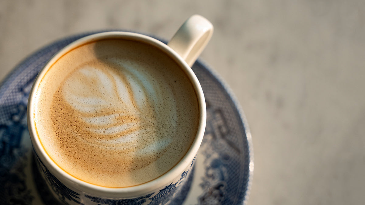 cappuccino in a fine cup on a marble countertop