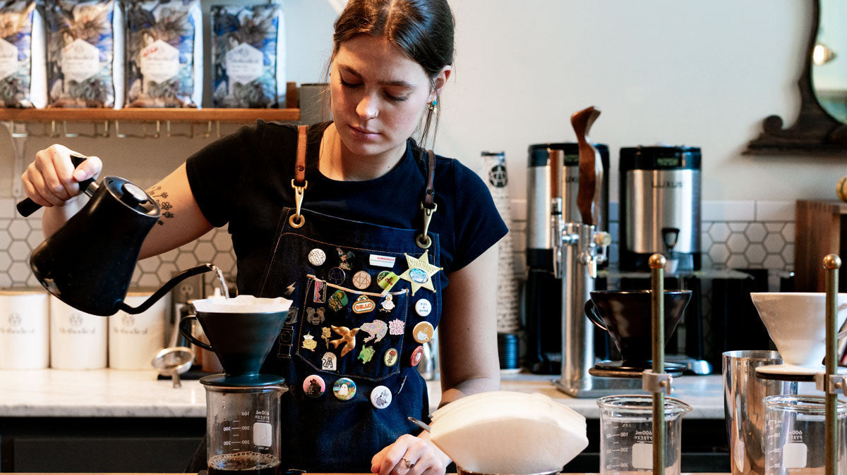 barista using a Stagg kettle to make pour over
