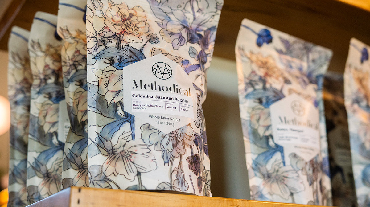 A coffee shop shelf stocked with bags of Methodical coffee beans