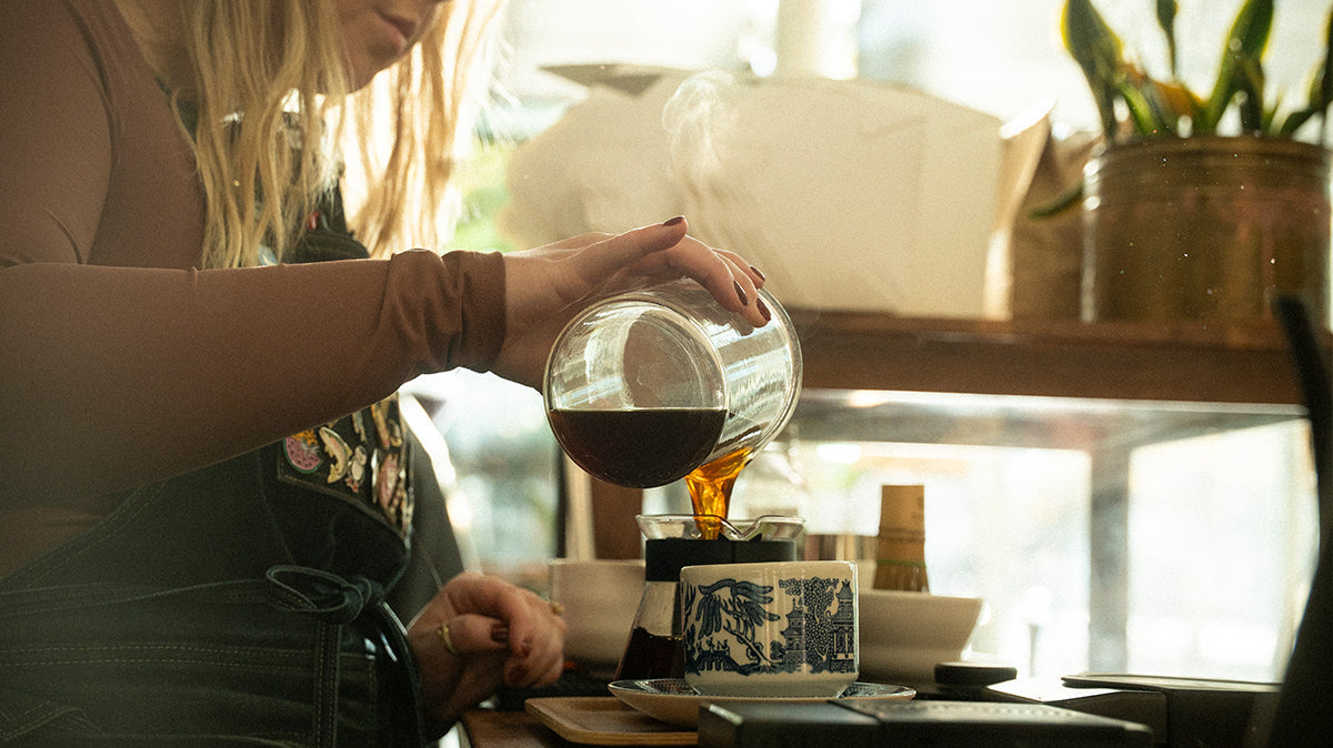 barista pouring a decaf coffee