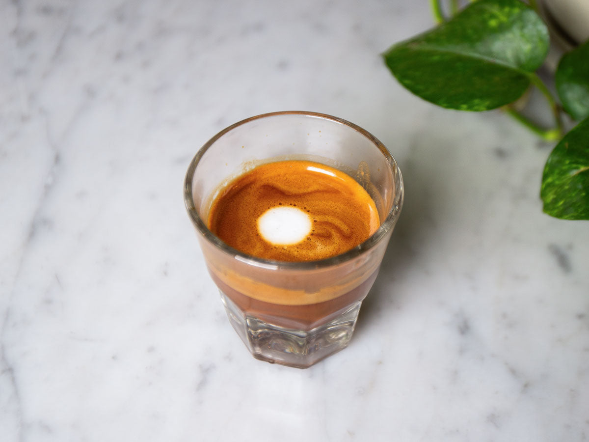 macchiato sitting on coffee bar counter