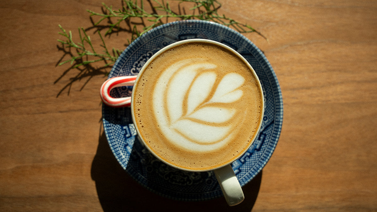 peppermint mocha with a candy cane on the side