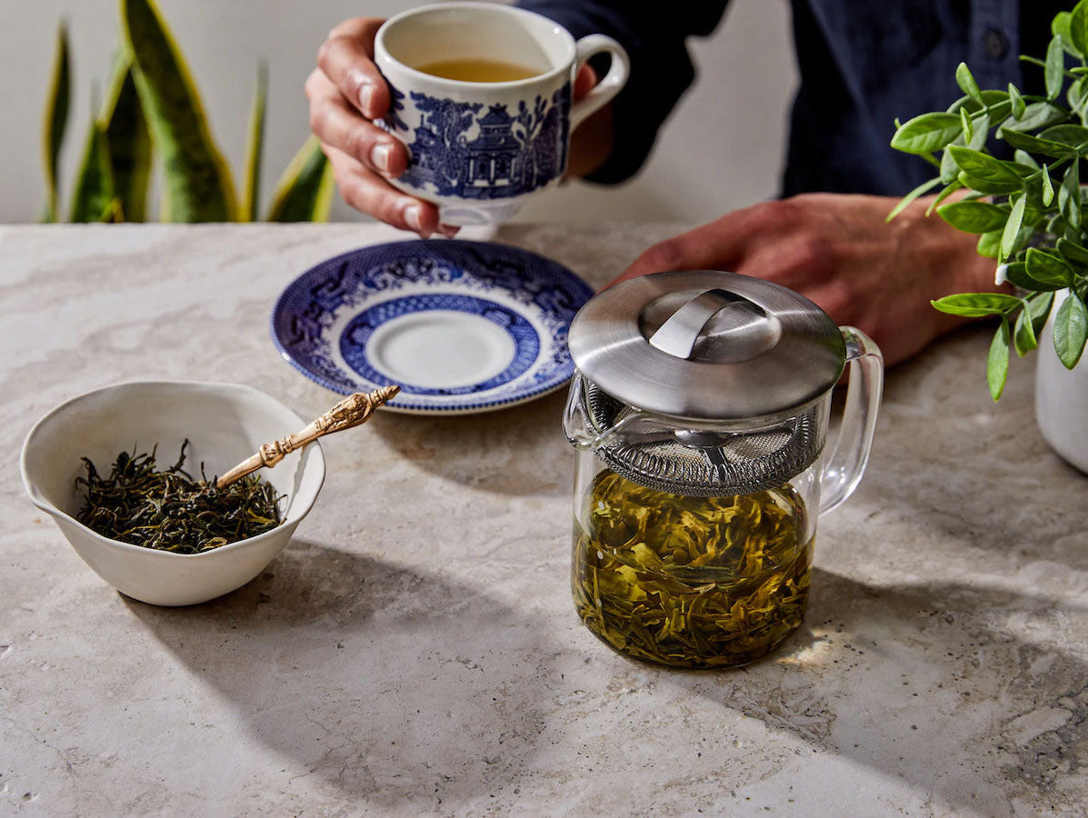 Person drinking tea with loose leaf tea