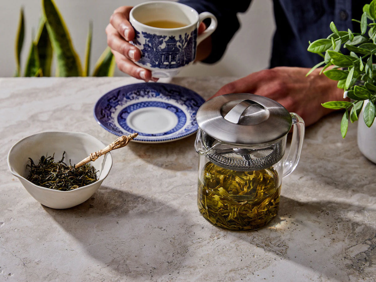 Person drinking tea with loose leaf tea