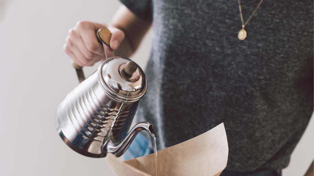 barista making a pour over coffee