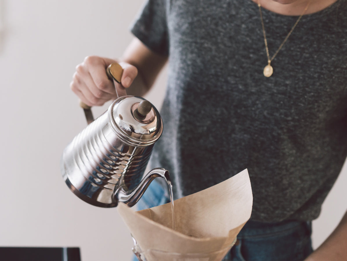 barista making a pour over coffee
