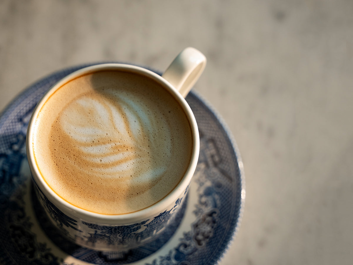 cappuccino in a fine cup on a marble countertop