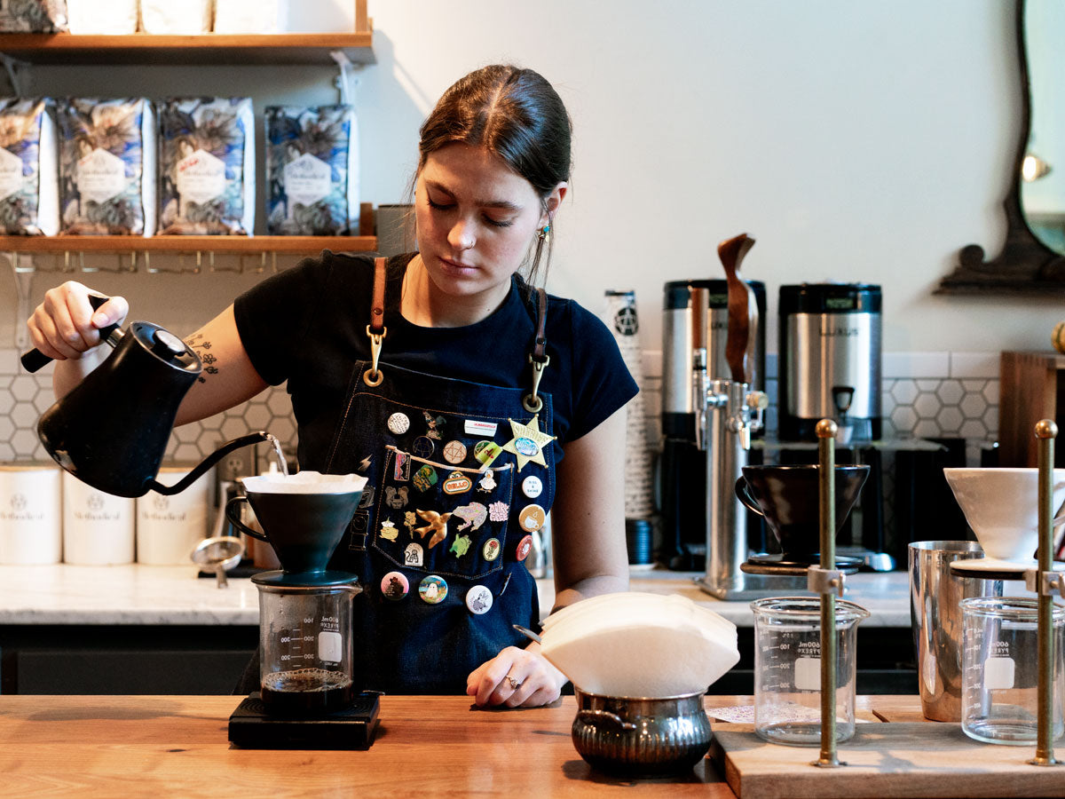 barista using a Stagg kettle to make pour over