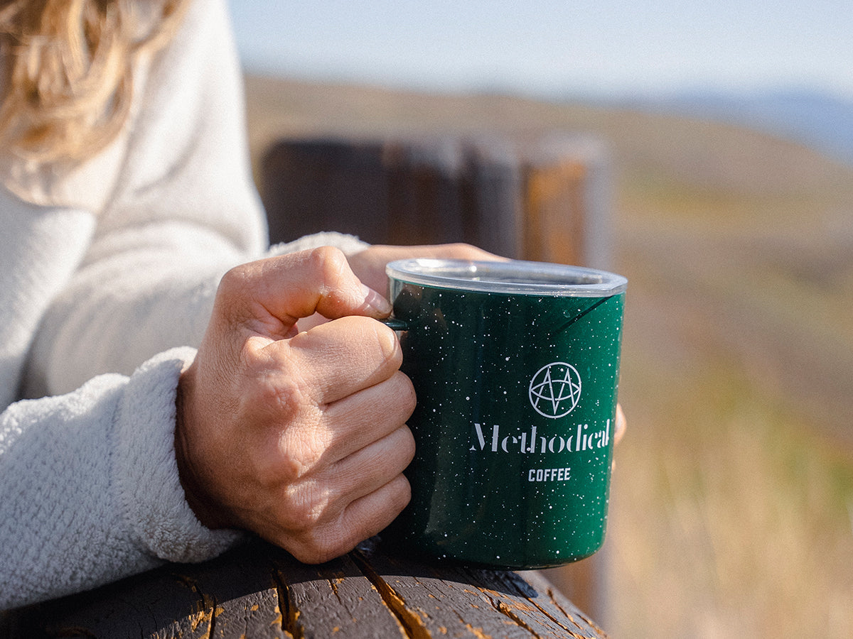 Woman holding a cup of coffee outside